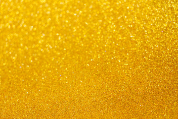 Christmas holiday festive glittering defocused golden background with bokeh lights