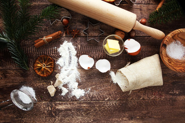 Fototapeta na wymiar Baking ingredients for homemade pastry on wooden background with cookies and spieces