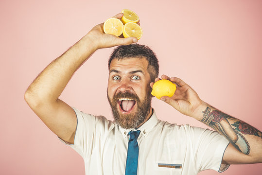happy man with long beard hold lemon.