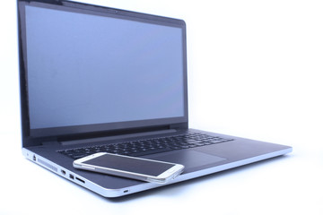 Office workplace with laptop, smart phone on table