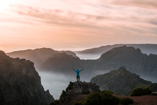 Adult male hiker celebrating the sunset over the mountain panorama of Madeira, Portugal
