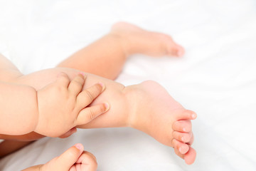 Newborn baby feets on white bed