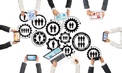 Top view of businesspeople sitting at table and using gadgets