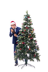 Businessman decorating christmas tree isolated on white