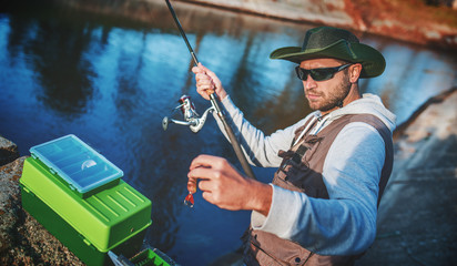 Angler enjoys in fishing on the river. Sport, recreation, lifestyle