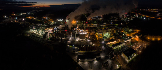 Aerial view of oil refinery. Industrial view at oil refinery plants with lots of light at night. Panorama.
