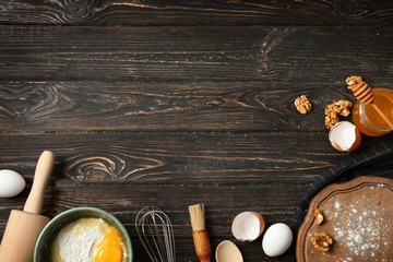 Kitchen utensils and food ingredients on wooden background