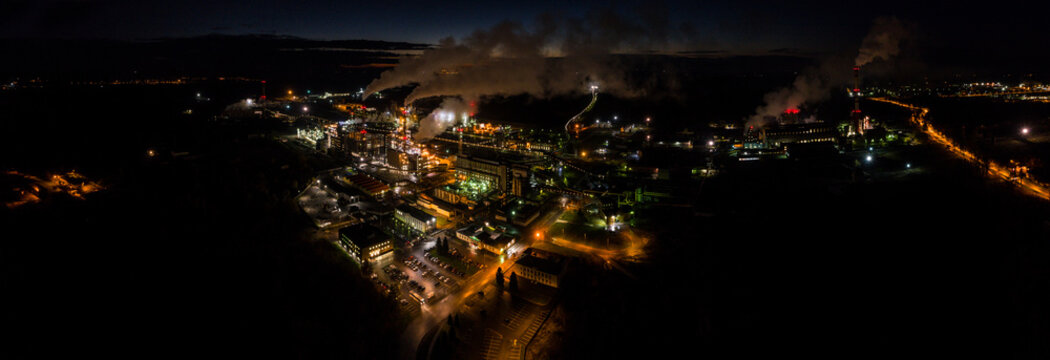 Aerial view of oil refinery. Industrial view at oil refinery plants with lots of light at night. Panorama.