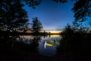 Fisherman in water at night. Night underwater fishing
