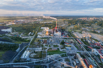 Aerial view Oil refinery with a background of mountains and sky at sunset.