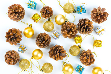 Christmas or New Year background with pine cones,gift box on red ribbon,golden ball of Xmas decorations and fir branches, flat lay, blank space for a greeting text on white