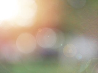 green blurred background with sunlight flare background