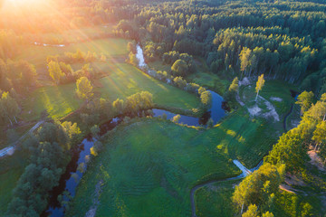 Fototapeta na wymiar Aerial View. Flying over the beautiful summer rivers at sunset.