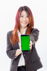 Fototapeta premium Defocused Asian woman holding out smartphone with green screen