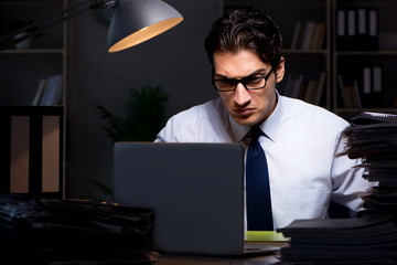 Young businessman working overtime late in office