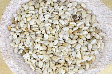 Seeds of sesame in a wooden spoon.