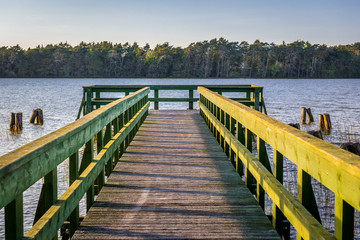 Naklejka premium Wooden platform on Dolgie Wielkie Lake near Baltic Sea coast in Slowinski National Park, Poland