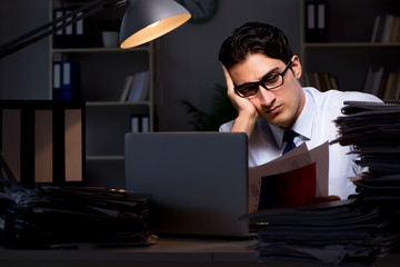 Young businessman working overtime late in office