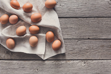 Fresh chicken brown eggs on linen, organic farming background