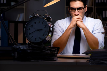 Young businessman working overtime late in office