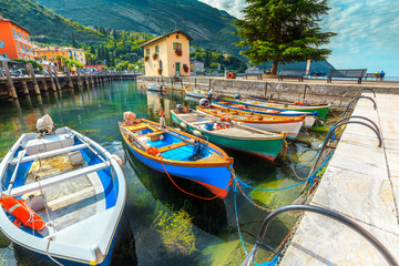 Fototapeta na wymiar Colorful fishing boats on the Garda lake, Torbole, Italy, Europe