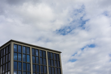 modern square building with cloudy sky