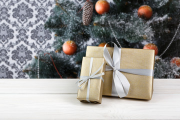 Christmas gifts on decorated tree background, holiday concept