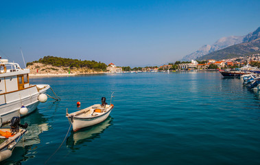 Fototapeta na wymiar Motor boats parked at pier in Makarska city. Popular tourist destination. Croatia
