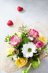 Valentine's day background or greeting card. A beautiful bouquet of flowers as a gift on a gray slate or stone background.