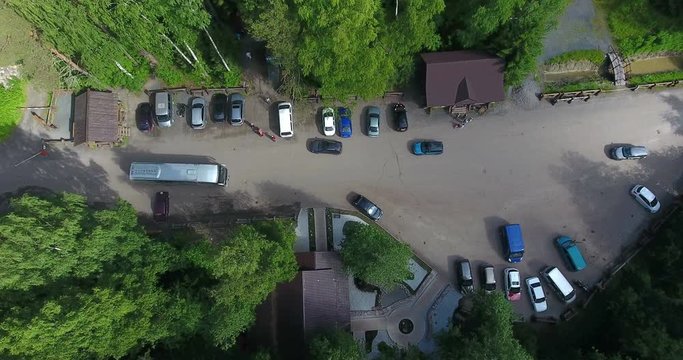 Car parking lot is in the area of the Kivach Reserve. Top view at the wooden houses of museums, the ticket office and entrance gate. Karelia, Russia