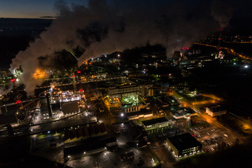 Fototapeta premium Aerial view of oil refinery. Industrial view at oil refinery plants with lots of light at night. 