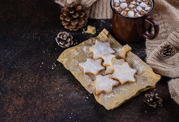 Hot Chocolate with marshmallow and Christmas Cookies Shape of Star On Stone Dark Table Backgriound. Top view. Cozy Winter Card Image Woman Sweater