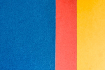 Blue, pink and yellow sheet of paper. Abstract background.