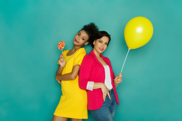 Two girlfriends posing at azur studio background