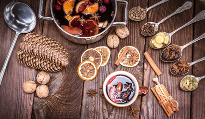 mulled wine in a brown cup and ingredients
