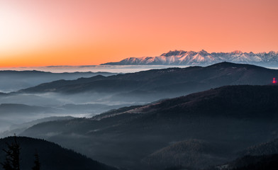 Obraz premium panorama over misty Gorce to snowy Tatra mountains in the morning, Poland landscape