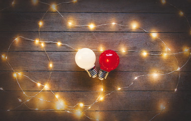 Light on bulbs on wooden background.