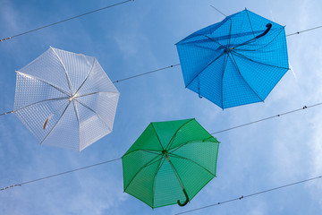 Street art with hanging blue, green and white umbrellas in Szentendre, Hungary