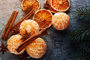 Juicy tangerine, cinnamon stick and anise stars on a glass plate