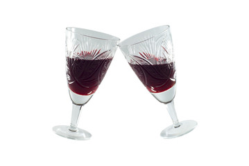 clinking vintage faceted crystal glasses (no hands) with red wine isolated
