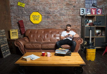 Man with smartphone at home