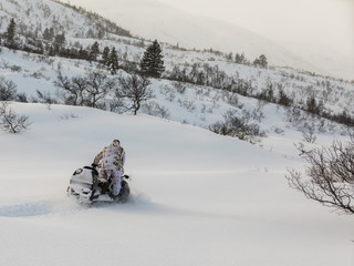 Man driving snowmobile in the snow