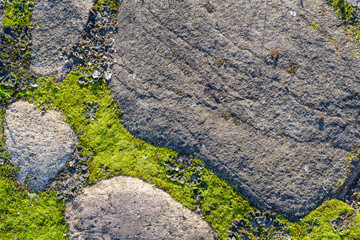 Fragment of the old road paved granite stones