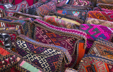 Bags, headgear, boxes made of traditional fabrics of Armenian patterns and colors lying on the stalls at the Yerevan market in Armenia