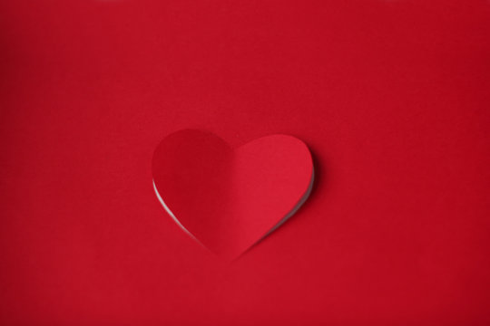 Heart cut in paper background