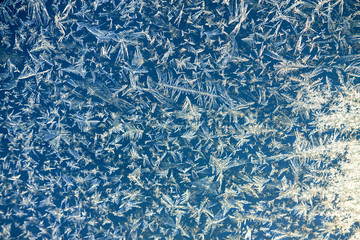 abstract blue  a white background from frosty pattern at a frosted window.