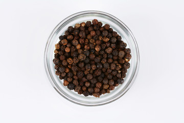 Black pepper in a glass container  on white background