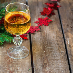 a solemn drink in a transparent glass on a table in a festive atmosphere