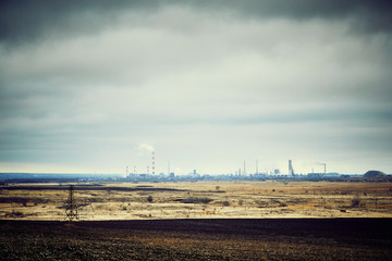 Chemical plant with chimney on the background of the sky.