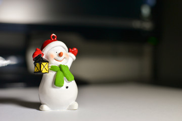 Snowman on the desktop in front of the computer
